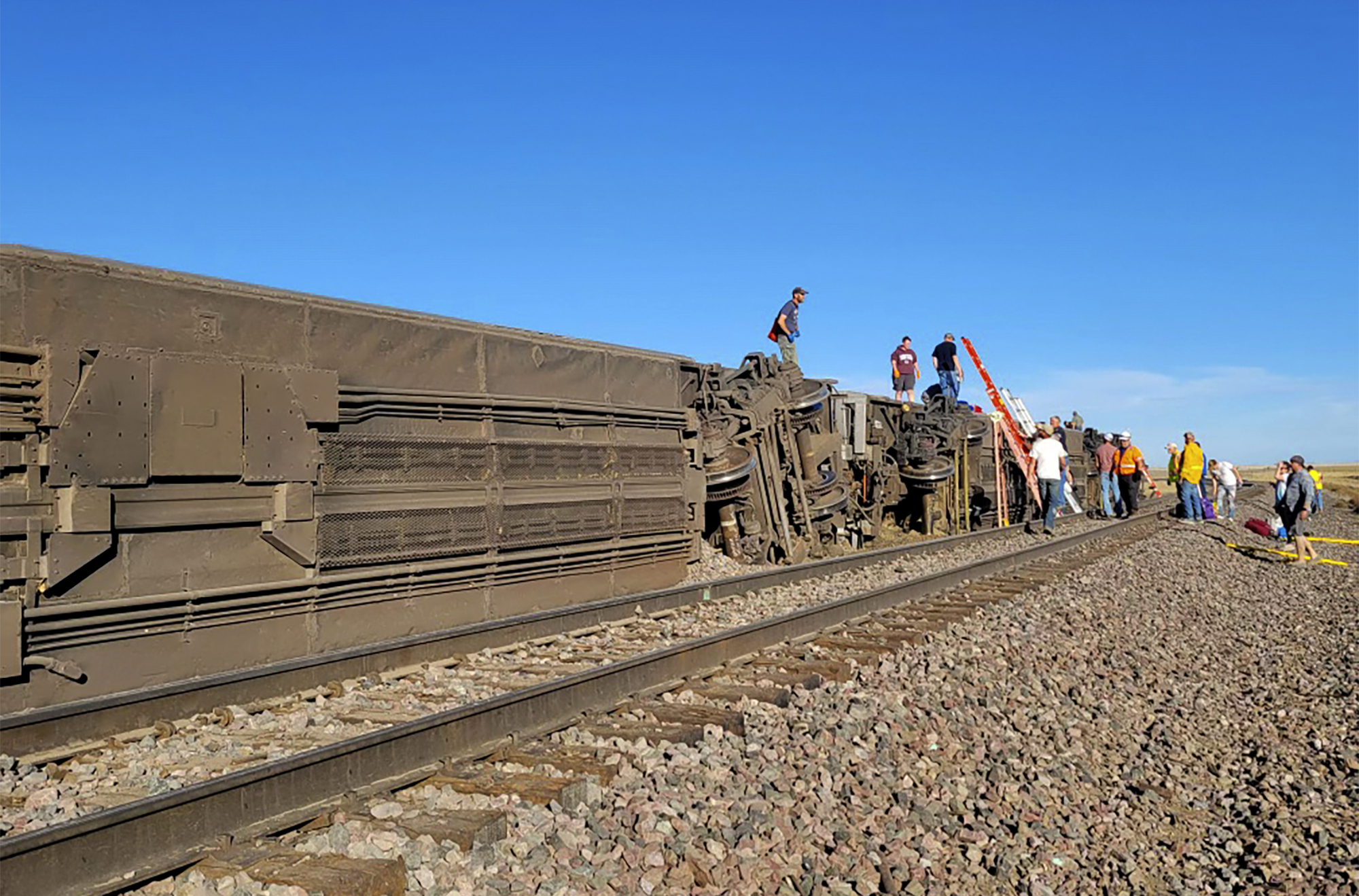 PHOTO: In this photo provided by Kimberly Fossen people work at the scene of an Amtrak train derailment on Saturday, Sept. 25, 2021, in north-central Montana.