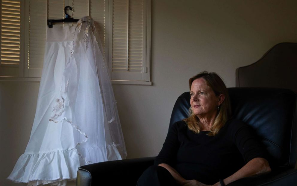 PHOTO: Karen McDonald, whose home was swept away in a mudslide, poses for photos with her wedding veil and the underskirt to her wedding dress she had worn 35 years earlier at her wedding, in Santa Barbara, Calif., April 11, 2018.