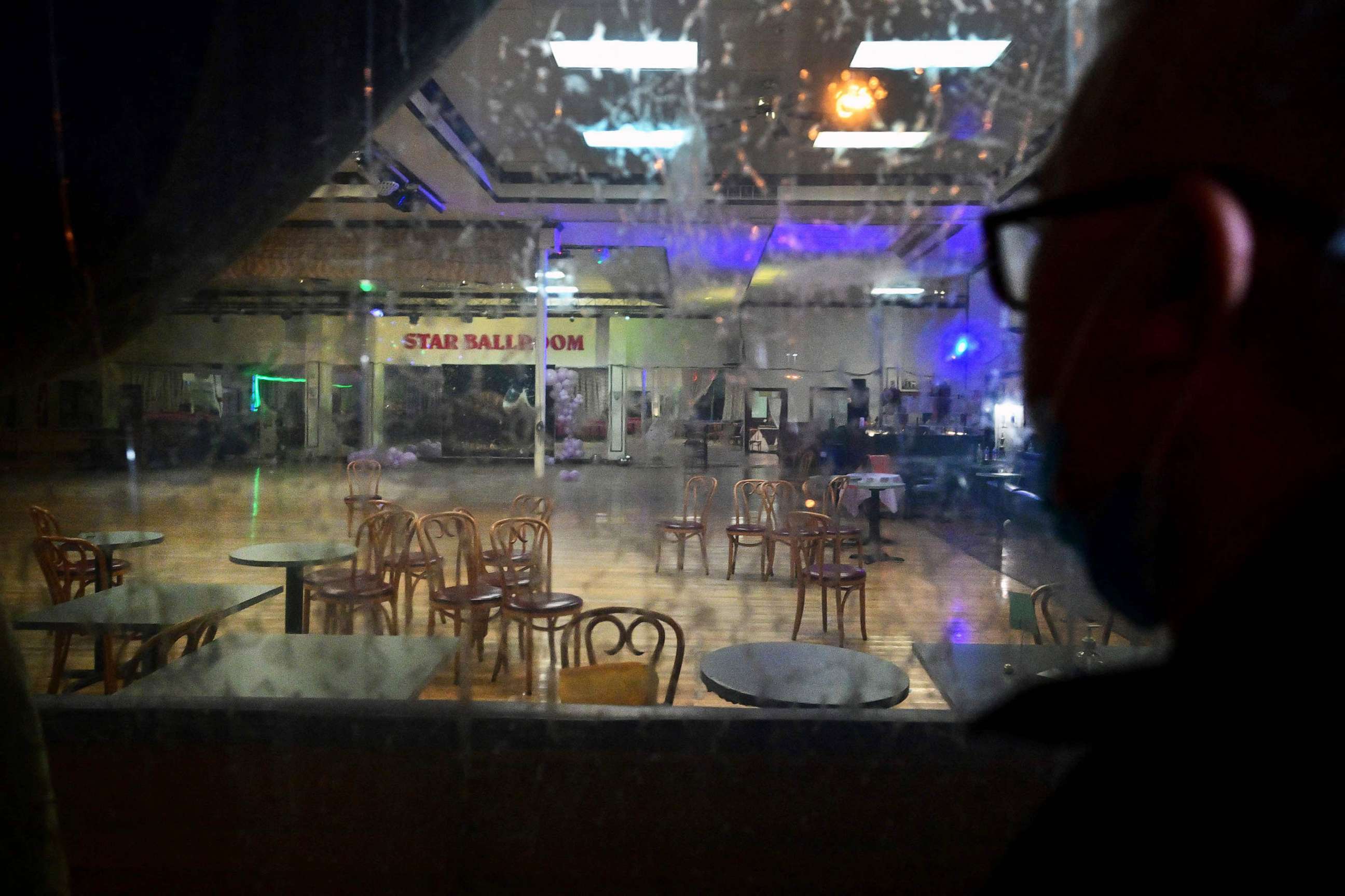 PHOTO: A man takes a closer look through the glass at the interior of The Star Dance Studio in Monterey Park, Calif., Jan. 23, 2023.