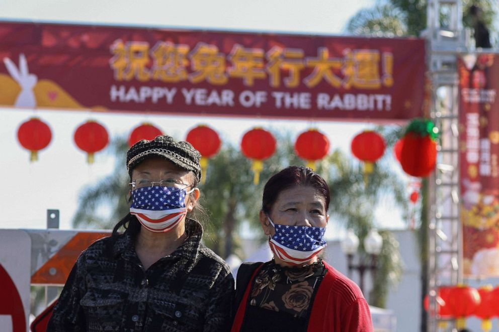 PHOTO: People look on from a street near the location of a shooting that took place during a Chinese Lunar New Year celebration, in Monterey Park, Calif., Jan. 22, 2023.