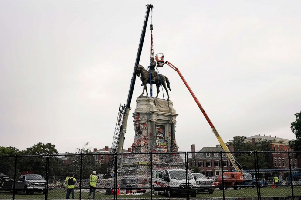 PHOTO: Crews work to remove one of the country's largest remaining monuments to the Confederacy, a towering statue of Confederate General Robert E. Lee on Monument Avenue, Sept. 8, 2021, in Richmond, Va.