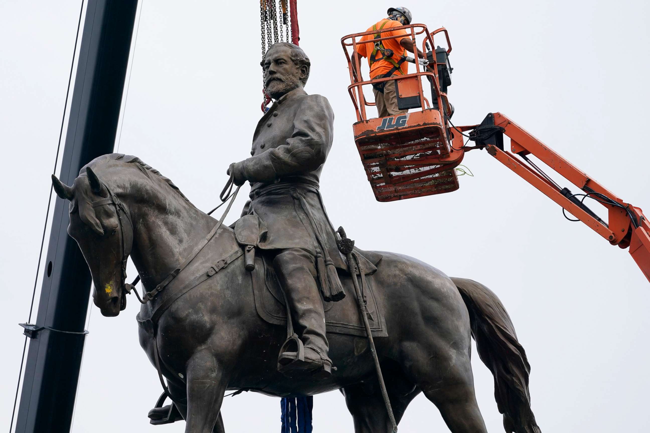 PHOTO: Crews work to remove one of the country's largest remaining monuments to the Confederacy, a towering statue of Confederate General Robert E. Lee on Monument Avenue, Sept. 8, 2021, in Richmond, Va. 