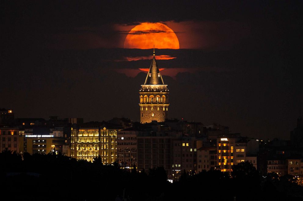 PHOTO: A supermoon rises behind the Galata Tower in Istanbul, June 14, 2022. 