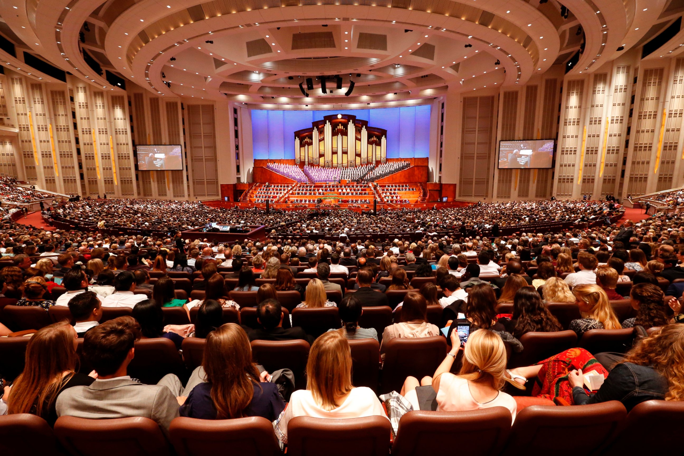 In this Sept. 30, 2017, file photo, people attend the morning session of the two-day Mormon church conference in Salt Lake City.