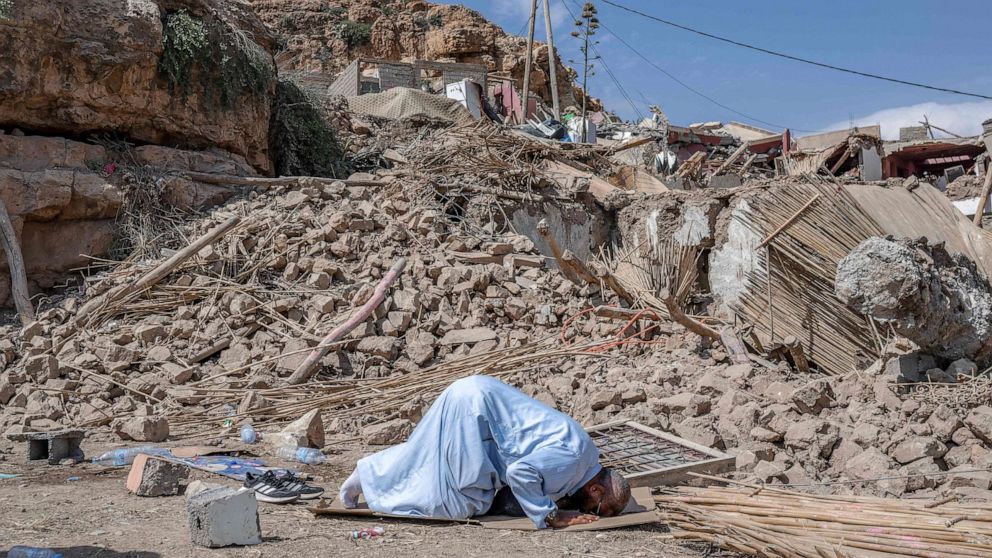 PHOTO: A man prays next to the rubble of an earthquake destroyed house in Imi N'Tala village near Amizmiz, Morocco on Sept. 12, 2023.