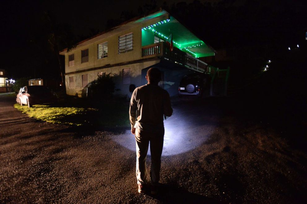 PHOTO: Fifty-six year old Jose Luis Gonzalez lights his path with a lantern on a street in Morovis, Puerto Rico, Dec. 21, 2017. Speaking about the flashbacks that he suffers, "Every time I close my eyes I see chaos...I still hear the screams in my head."