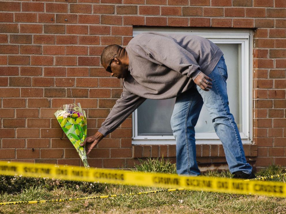 PHOTO: A man places flowers at the Robert Morris Apartments in Morrisville, Pa., Feb. 26, 2019.