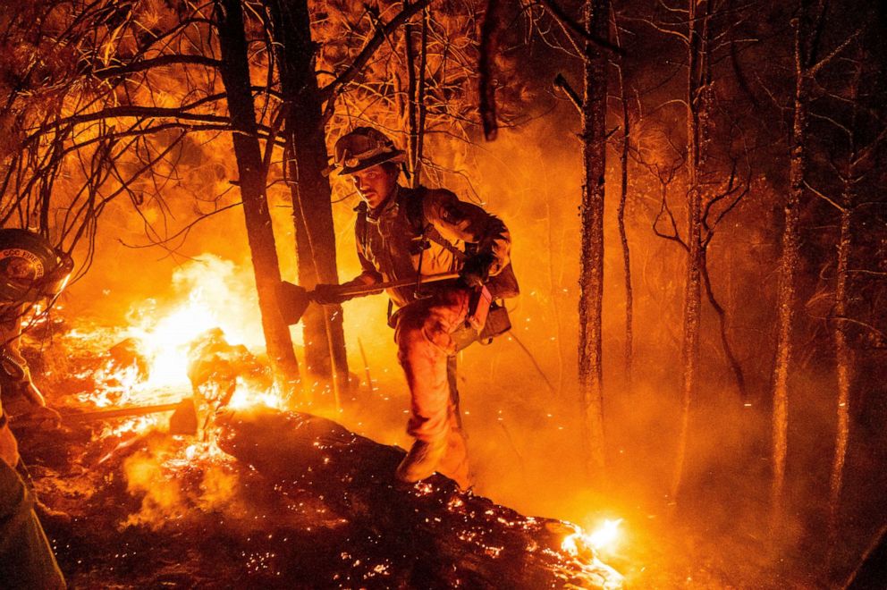 PHOTO: Firefighter Christian Mendoza manages a backfire, flames lit by firefighters to burn off vegetation, while battling the Mosquito Fire in Placer County, Calif., on Tuesday, Sept. 13, 2022.