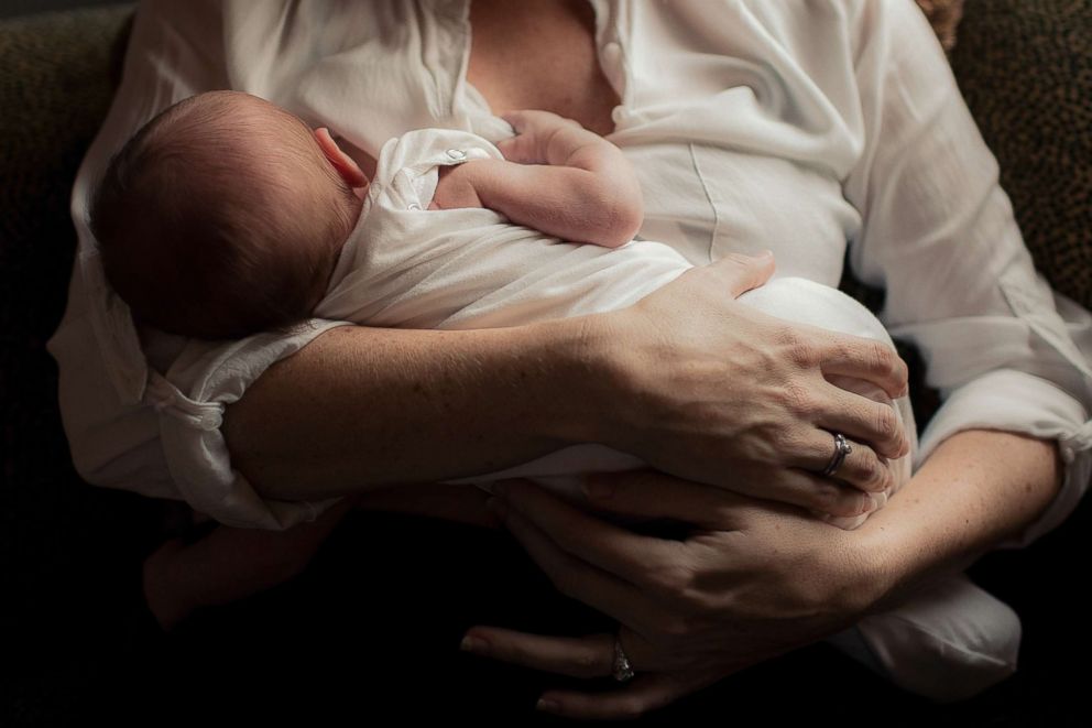 PHOTO: A woman breastfeeds a newborn baby in an undated stock photo.