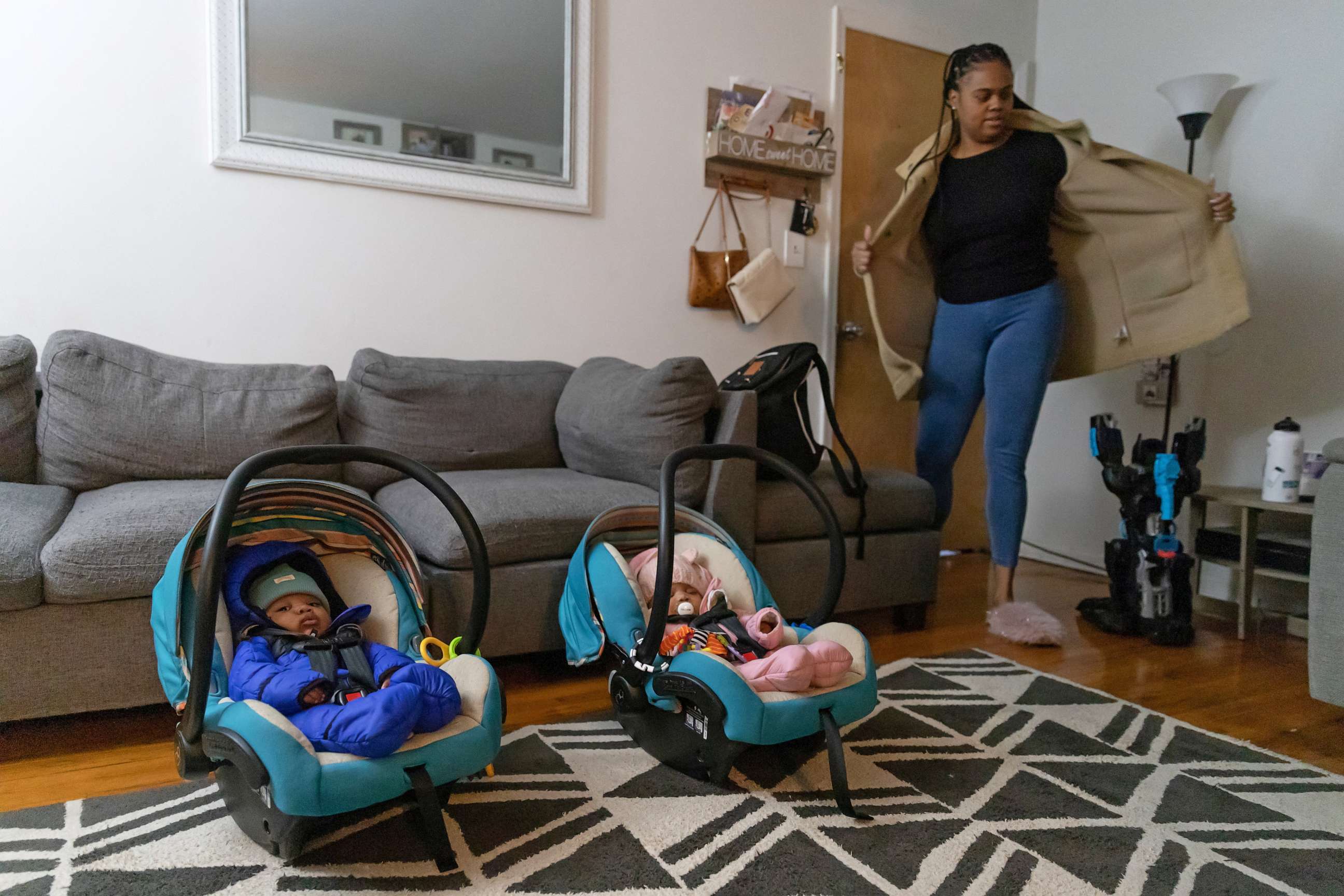 PHOTO: Chelsea Ward, 32, takes her coat off after picking up her seven-month-old twins, Callie Rae Polen and Cai Ryan Polen, from daycare in Fords, N.J., Jan. 13, 2023.