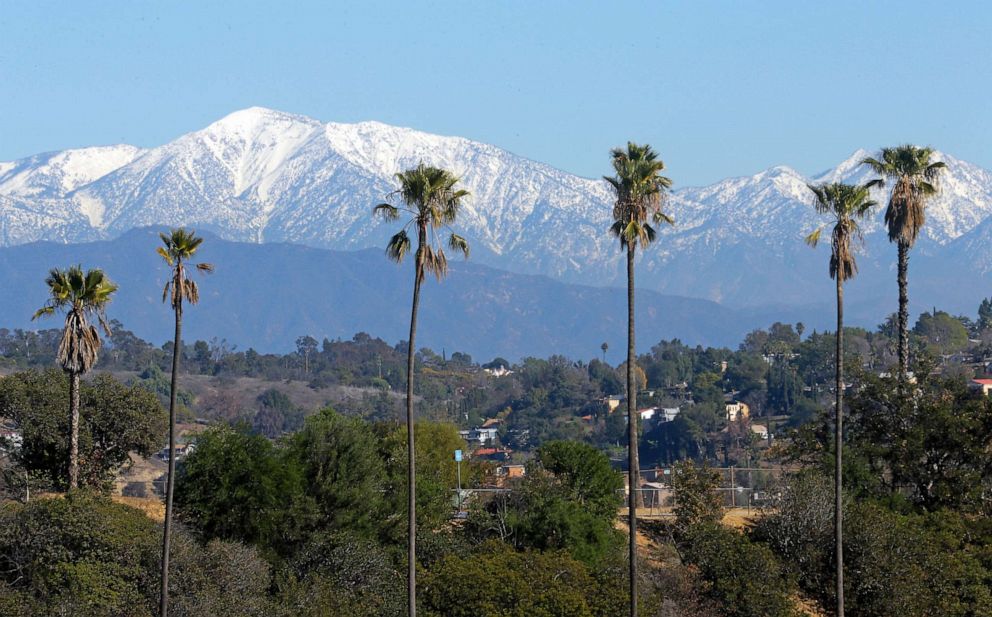 PHOTO: The snow-capped San Gabriel Mountains, with Mount Baldy the highest peak at the left, as seen from Chinatown near downtown Los Angeles, Jan. 12, 2016.