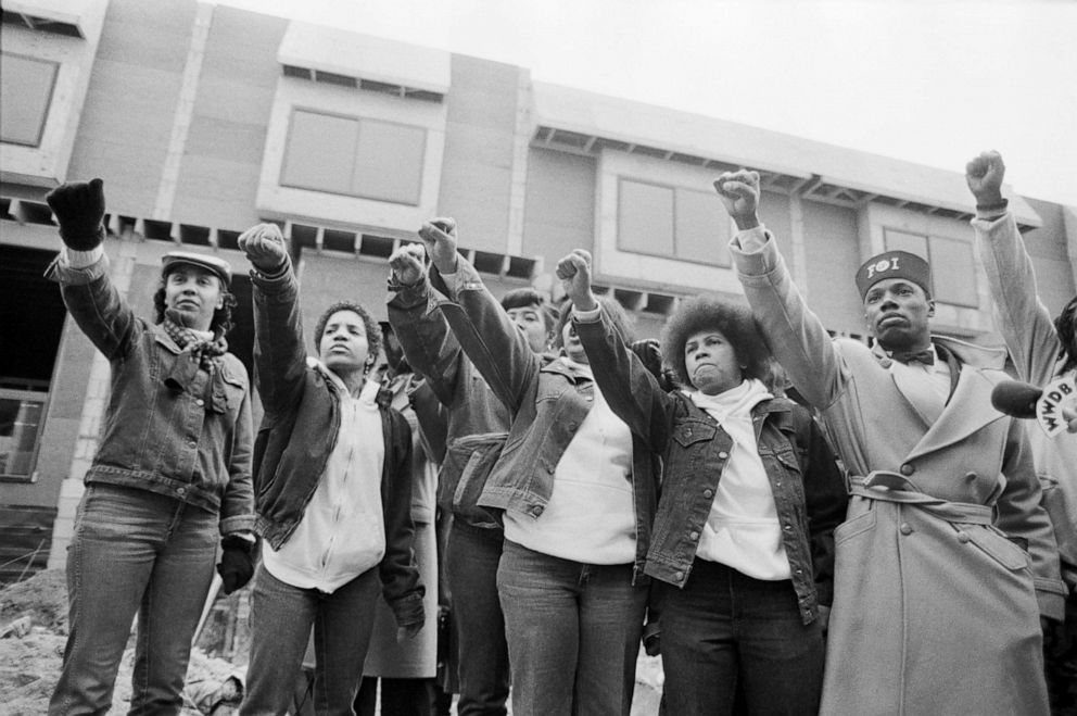 PHOTO: Mourners of MOVE members killed in the bombing by the Philadelphia Police stand in front of their former headquarters in Philadelphia on Dec. 5, 1985.