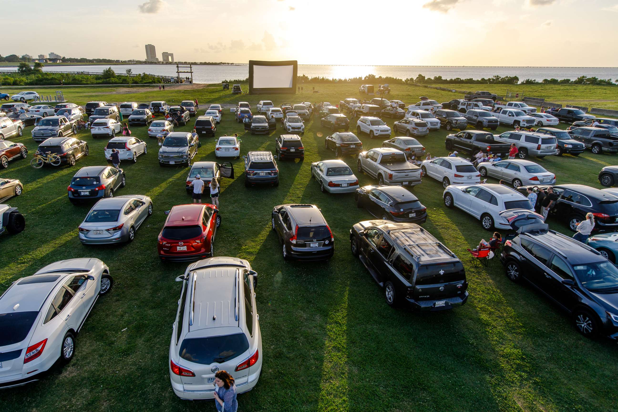 PHOTO: Attendees arrive to watch the movie "Grease" at a pop-up drive-in theatre at Bucktown Marina Park on May 22, 2020 in Metairie, La.