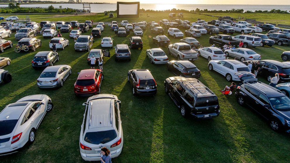 PHOTO: Attendees arrive to watch the movie "Grease" at a pop-up drive-in theatre at Bucktown Marina Park on May 22, 2020 in Metairie, La.