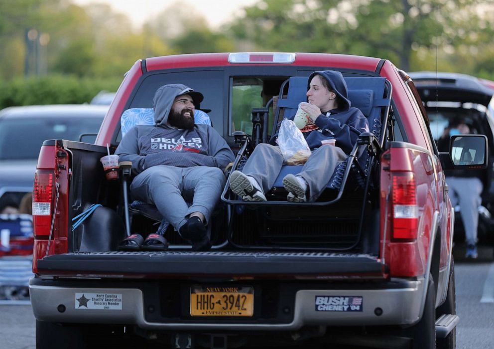 PHOTO: Attendees arrive to watch the movie "The Goonies" at a pop-up drive-in theatre built in the parking lot at the Broadway Commons on May 21, 2020 in Hicksville, N.Y.