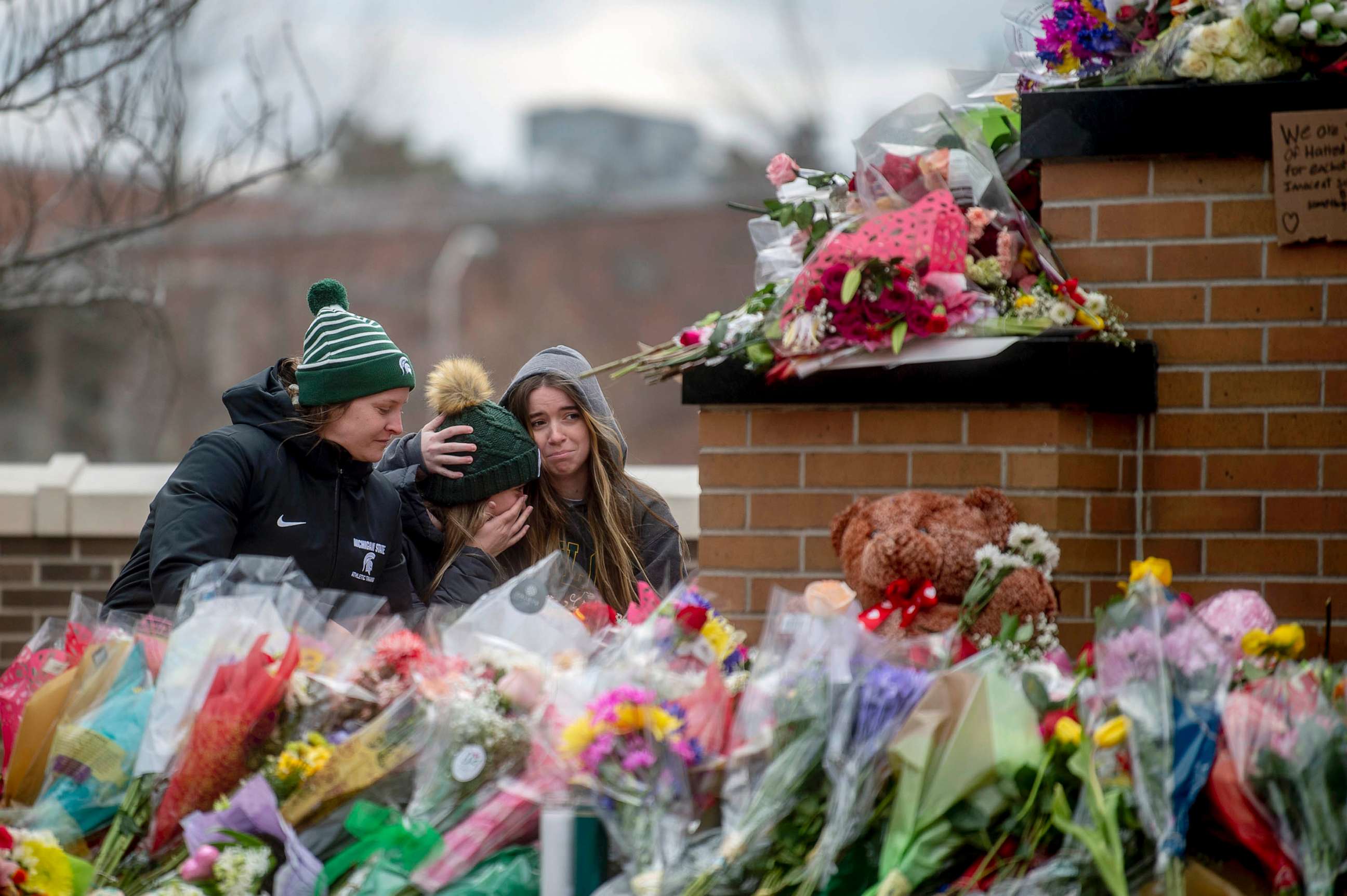 PHOTO: FILE - Michigan State freshman McKenzie English and Carolina Gorinkowski console one another alongside Alyssa Pollard-McGrandy where a makeshift memorial continues to grow, Feb. 15, 2023, in East Lansing, Mich.