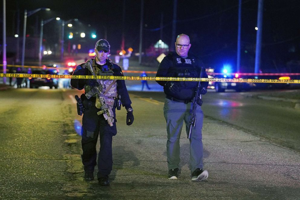 PHOTO: Police officers walk near the scene where the suspect was located as they respond to a shooting at Michigan State University in East Lansing, Mich., Feb. 14, 2023.