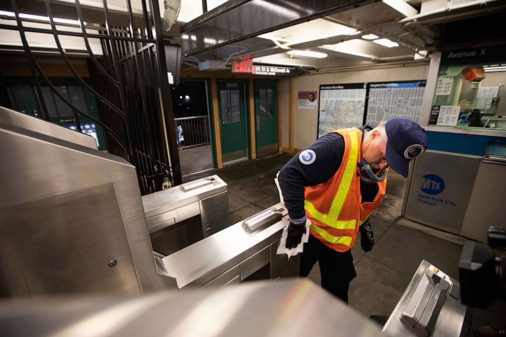 PHOTO: Metropolitan Transportation Authority worker Duane Clark sanitizes surfaces at the Avenue X subway station in the Brooklyn borough of New York City, March 3, 2020.