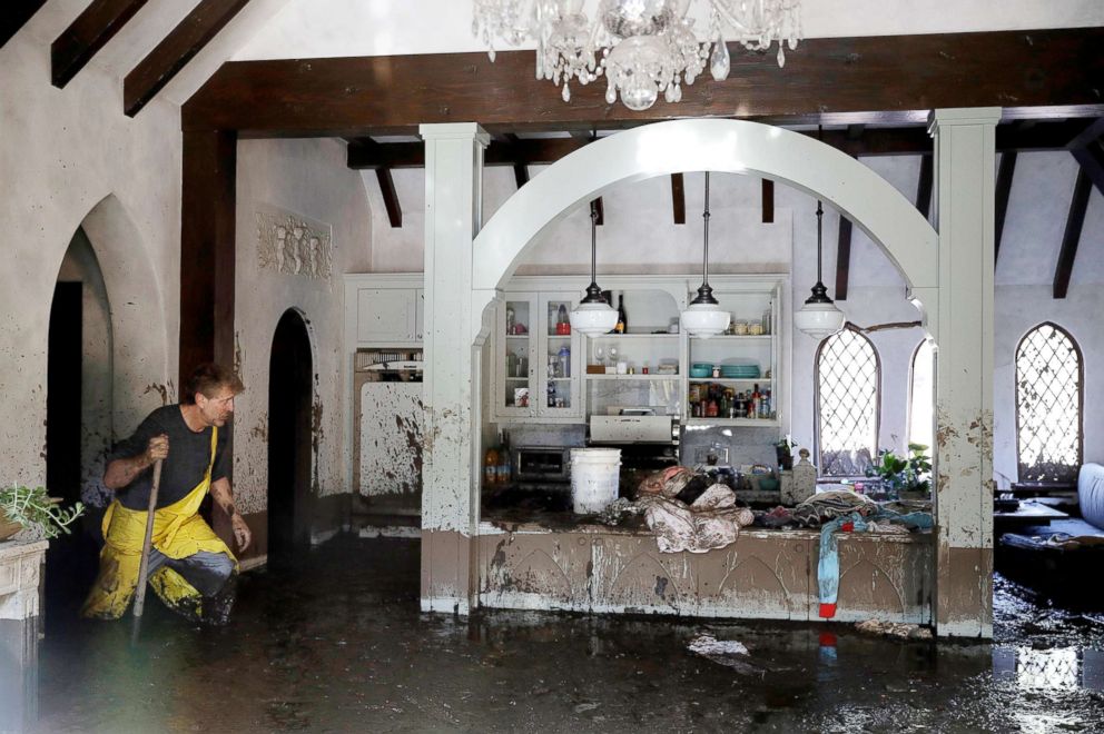 PHOTO: Bill Asher walks through mud in his home damaged by storms in Montecito, Calif., Thursday, Jan. 11, 2018.