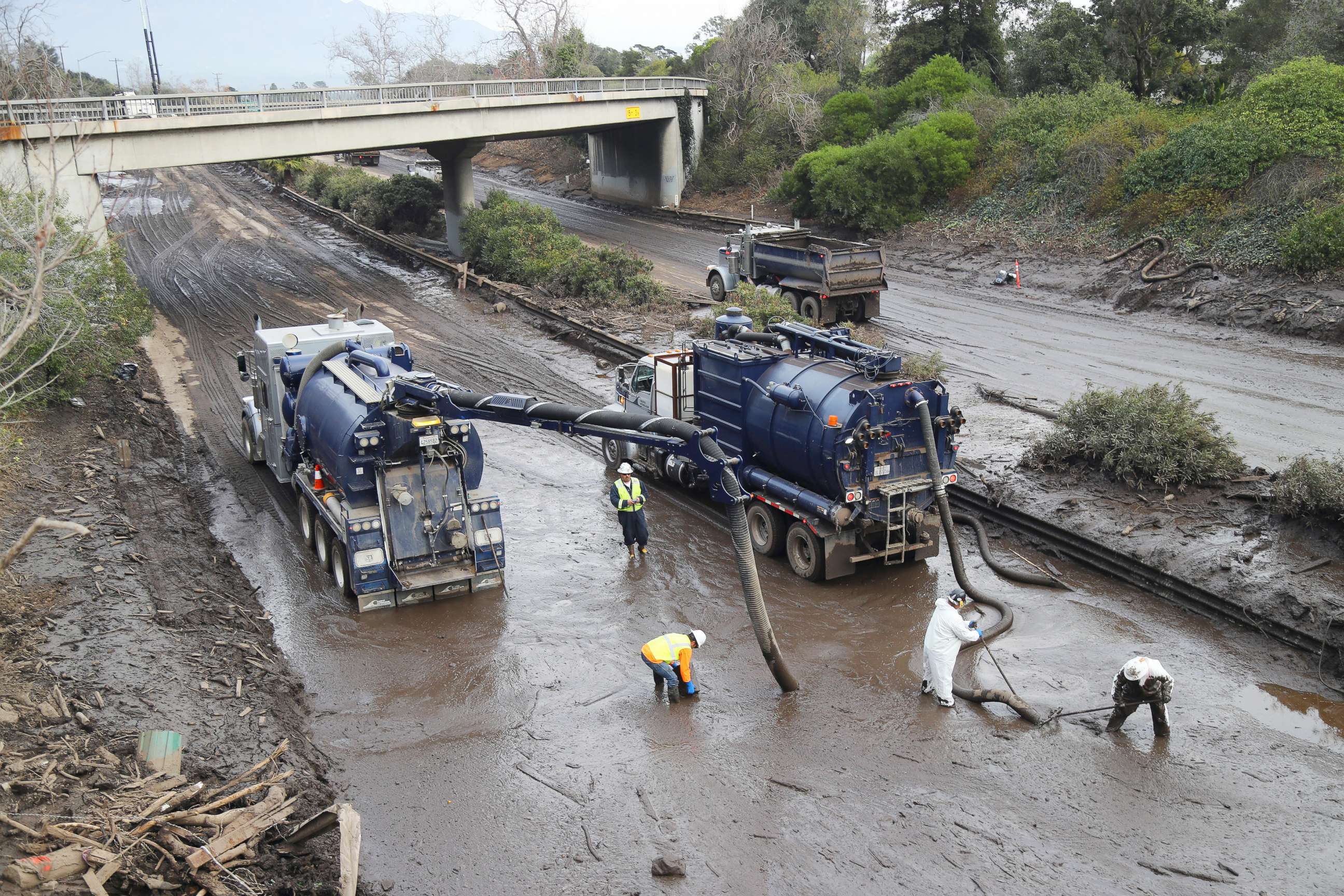 PHOTO: Vacuum trucks are used  to clear the muck left by the mudslide from Highway 101 in Montecito, Calif., Jan. 15, 2018.