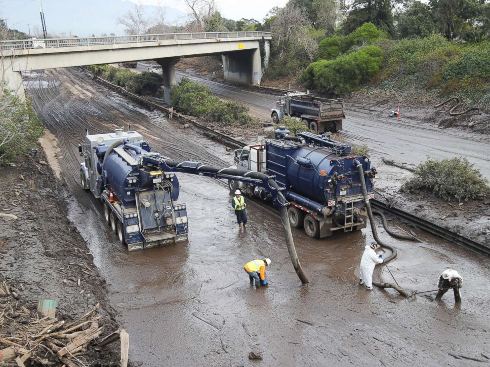 PHOTO: Workers use vacuum trucks to clear the muck left by the mudslide from Highway 101 in Montecito, Calif., Jan. 15, 2018.