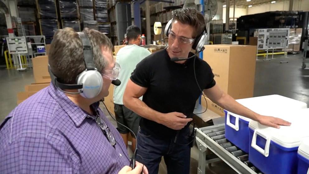 PHOTO: "World News Tonight" anchor David Muir speaks with Vice President of Operations, Michael Mihelick, at the Igloo Coolers factory in Katy, Texas.