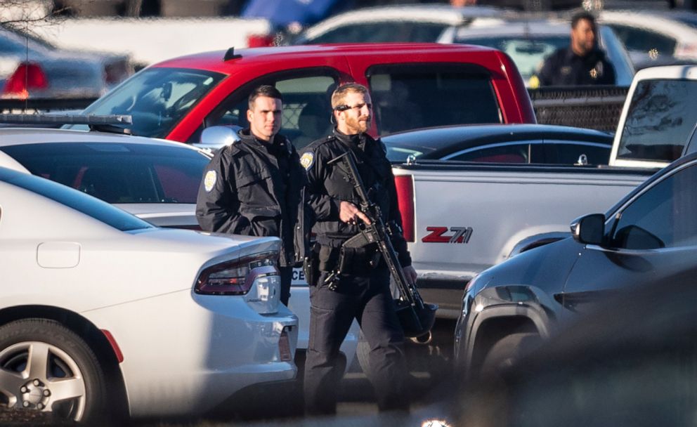 PHOTO: A police officer with the Winston-Salem Police Department walks across the parking lot of the Joycelyn V. Johnson Municipal Services Center after reports of gunshots in Winston-Salem, N.C., Dec. 20, 2019.