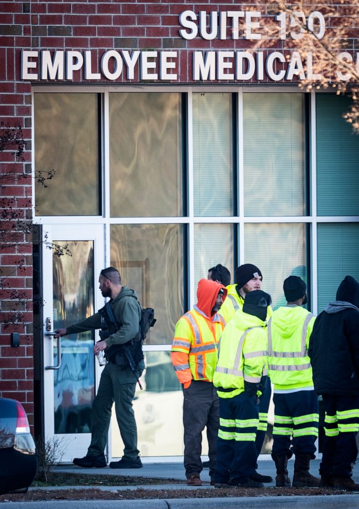 PHOTO: City employees and a police officer with the Winston-Salem Police Department stand outside of the Joycelyn V. Johnson Municipal Services Center after reports of gunshots in Winston-Salem, N.C., Dec. 20, 2019.