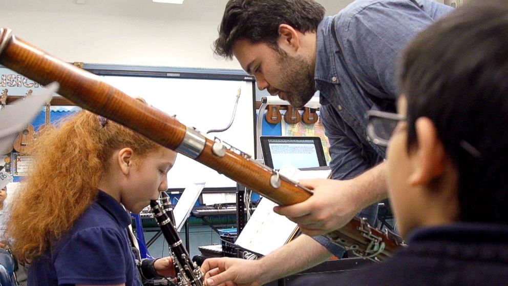 PHOTO: Remy Taghavi provides musical instruction to a student at P.S. 63 in Queens, NY. 