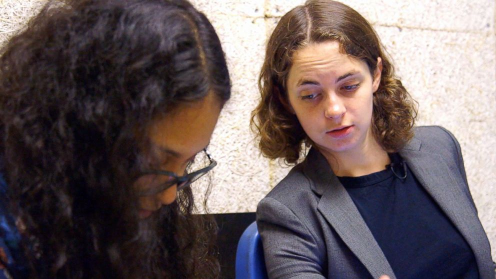 PHOTO: Bassist Lizzie Burns is pictured helping a student with an assignment at Celia Cruz Bronx High School of Music.