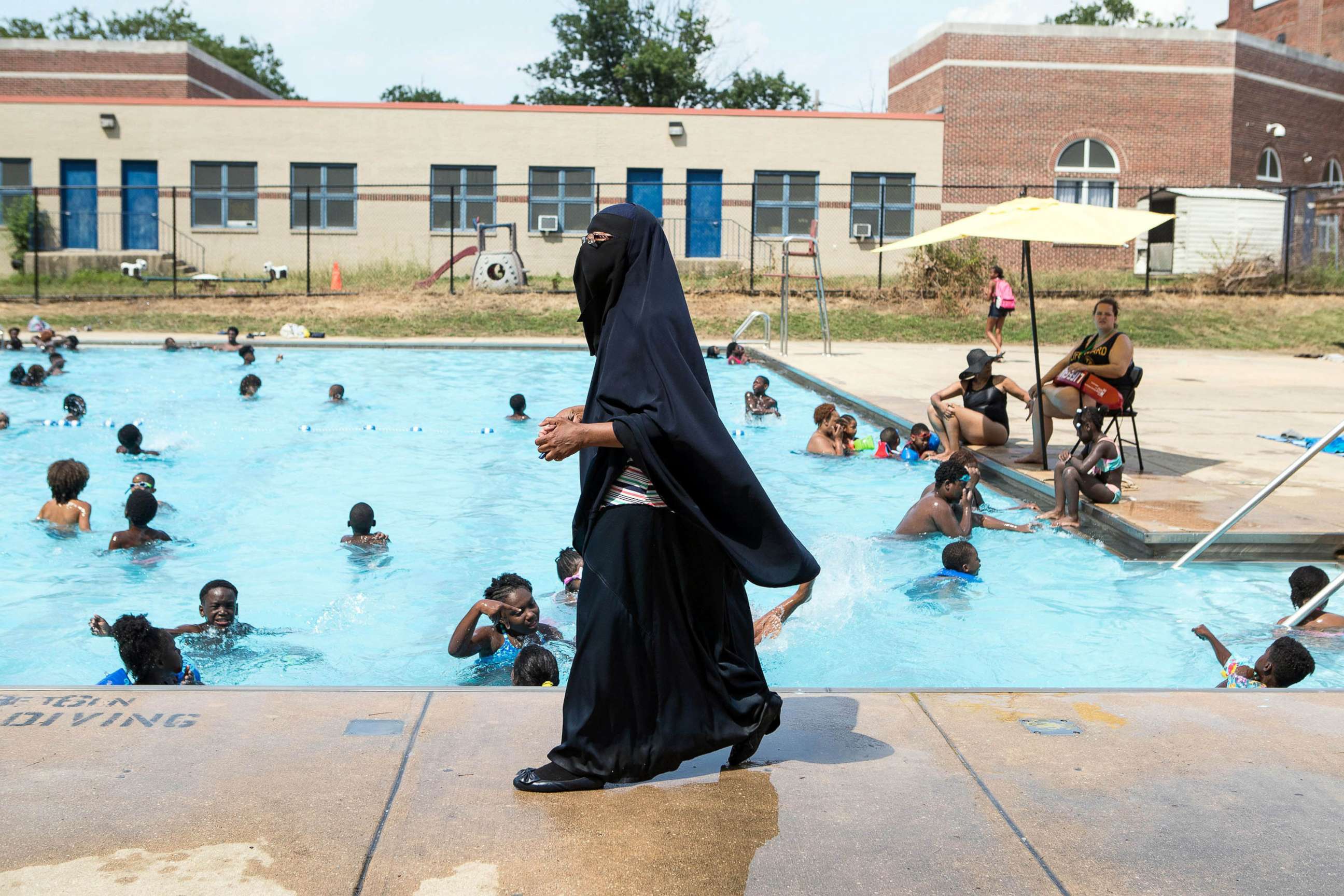 PHOTO: Director of Darul-Amaanah Academy Tahsiyn Ismaa'eel watches over swimmers from her school, July 12, 2018 at Dr. Foster M. Brown Pool in Wilmington, Del.