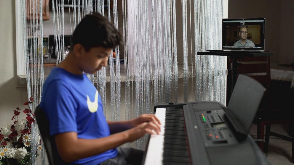 PHOTO: 13-year-old Mustafa Aria, an Afghan-American who escaped Kabul during the Taliban take over, is now taking music lessons with Music composer Russell Daisey, to help him process the trauma he experienced during his escape.