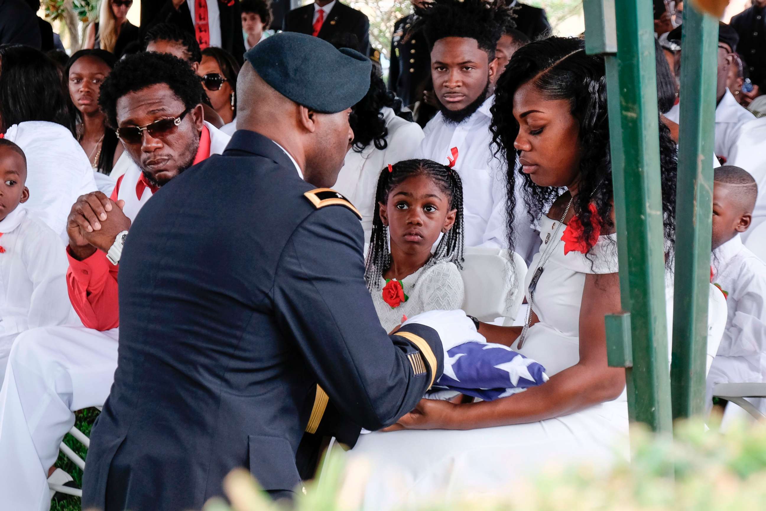 PHOTO: Myeshia Johnson is presented with a folded U.S. flag by a military honor guard member during the burial service for her husband U.S. Army Sgt. La David Johnson at the Memorial Gardens East cemetery, Oct. 21, 2017, in Hollywood, Fla.

