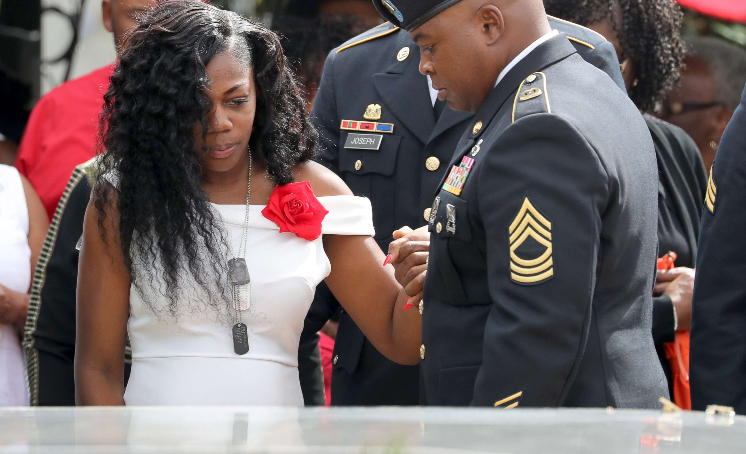 PHOTO: Myeshia Johnson, the wife of Army Sgt. La David Johnson at his casket after the burial at Hollywood Memorial Gardens, Oct. 21, 2017.