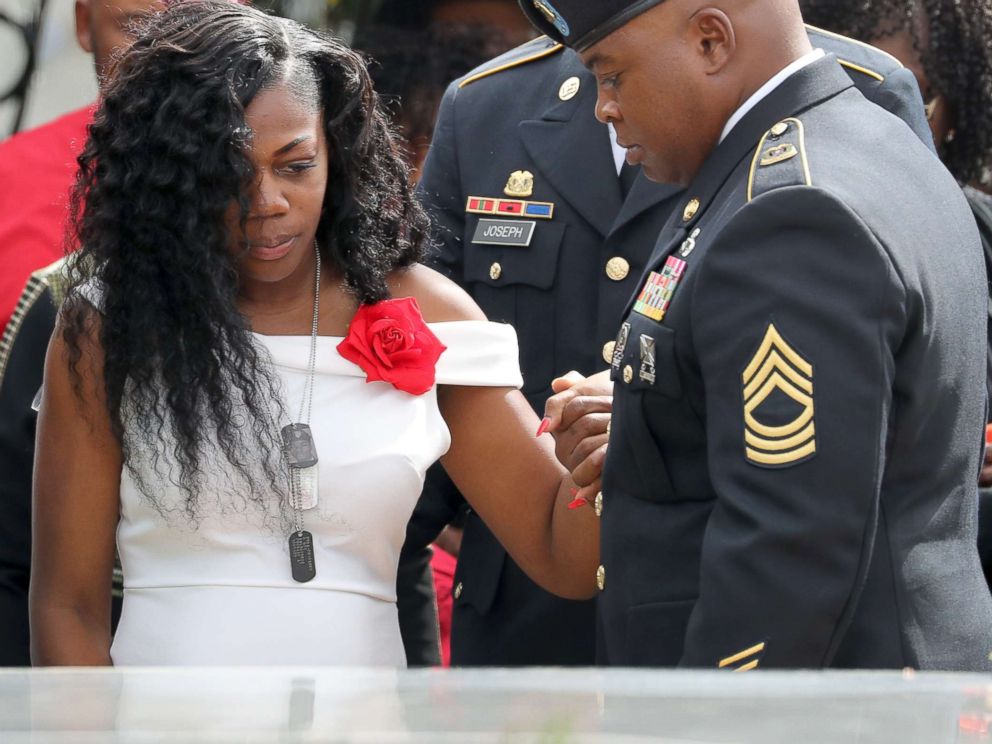 PHOTO: Myeshia Johnson, the wife of Army Sgt. La David Johnson at his casket after the burial at Hollywood Memorial Gardens, Oct. 21, 2017.