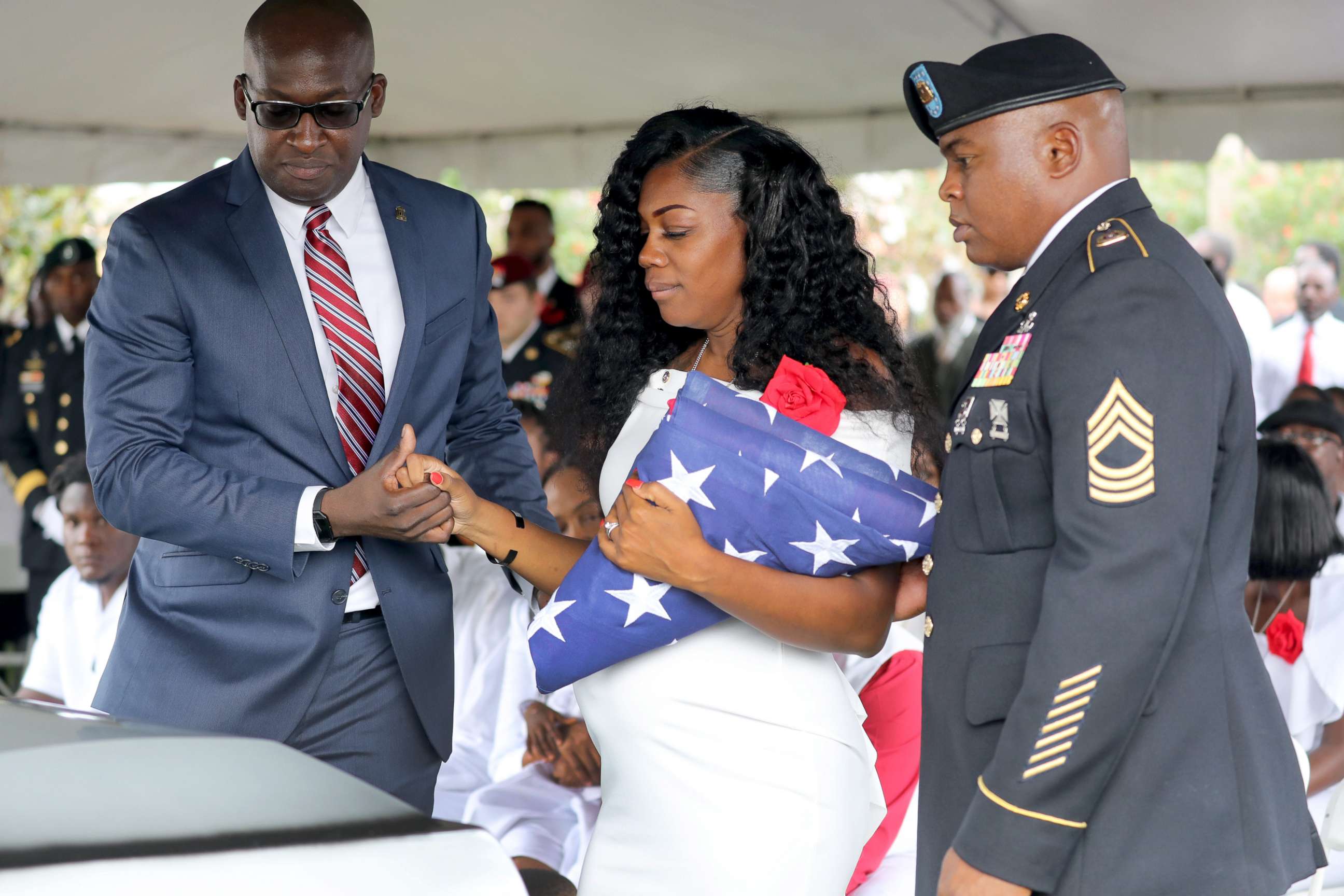 PHOTO: Myeshia Johnson, the wife of Army Sgt. La David Johnson, looks down at his casket after the burial at Hollywood Memorial Gardens, Oct. 21, 2017, in Ft. Lauderdale, Fla.