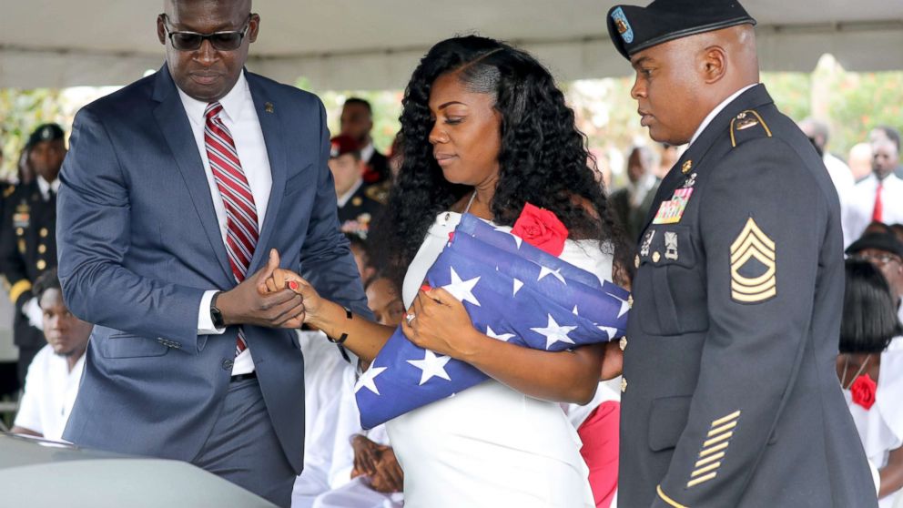 PHOTO: Myeshia Johnson, the wife of Army Sgt. La David Johnson, looks down at his casket after the burial at Hollywood Memorial Gardens, Oct. 21, 2017, in Ft. Lauderdale, Fla.