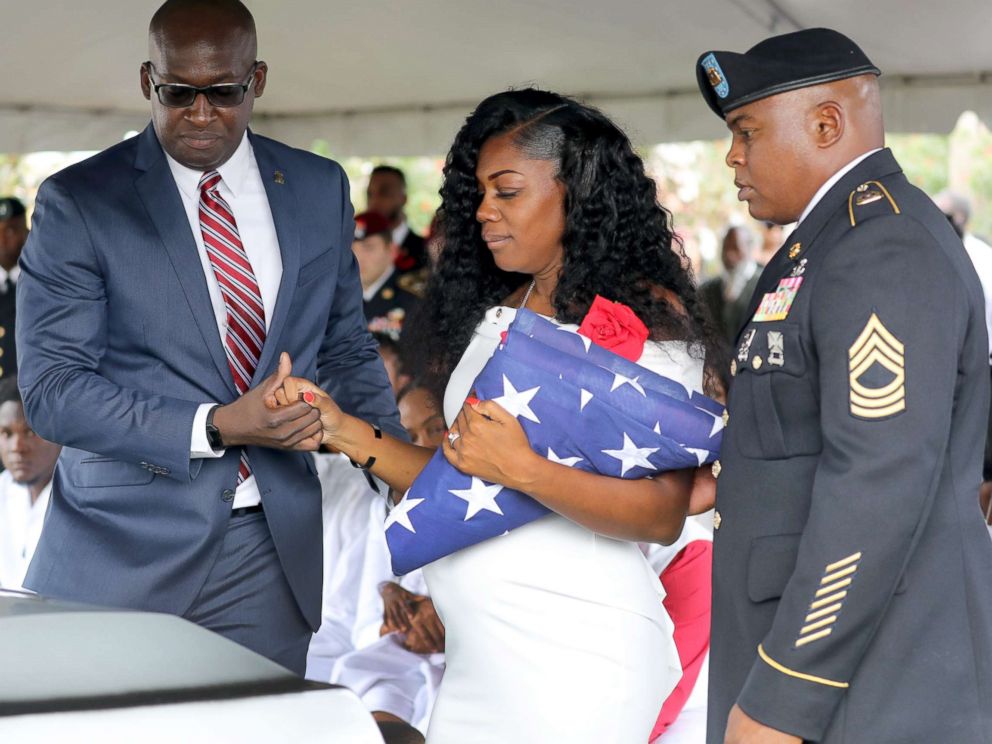 PHOTO: Myeshia Johnson, the wife of Army Sgt. La David Johnson, looks down at his casket after the burial at Hollywood Memorial Gardens, Oct. 21, 2017, in Ft. Lauderdale, Fla.