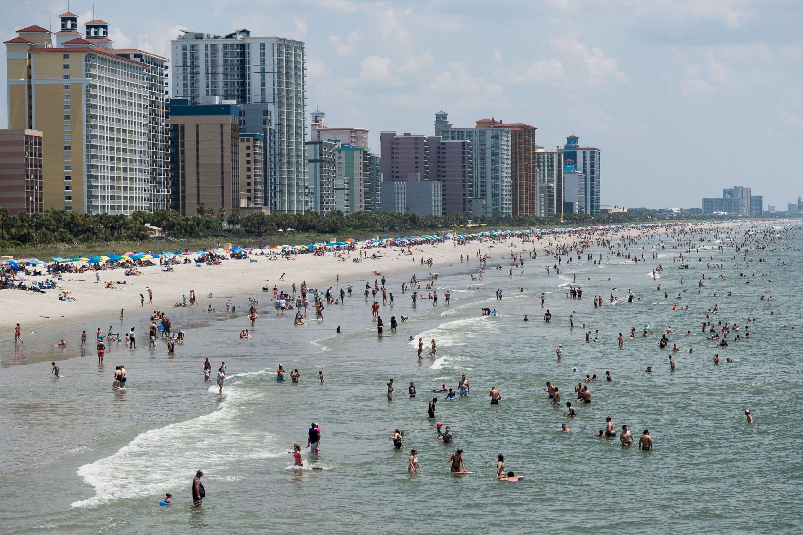 PHOTO: People wade in the ocean on July 4, 2020, in Myrtle Beach, S.C.