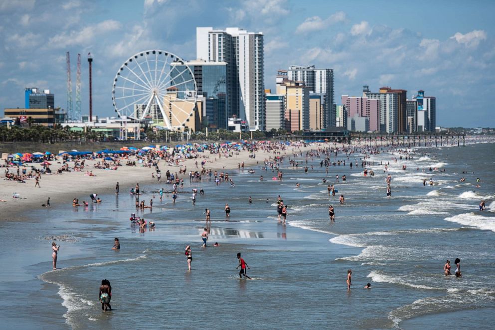 PHOTO: People wade in the surf in this file photo on May 23, 2020 in Myrtle Beach, S.C.