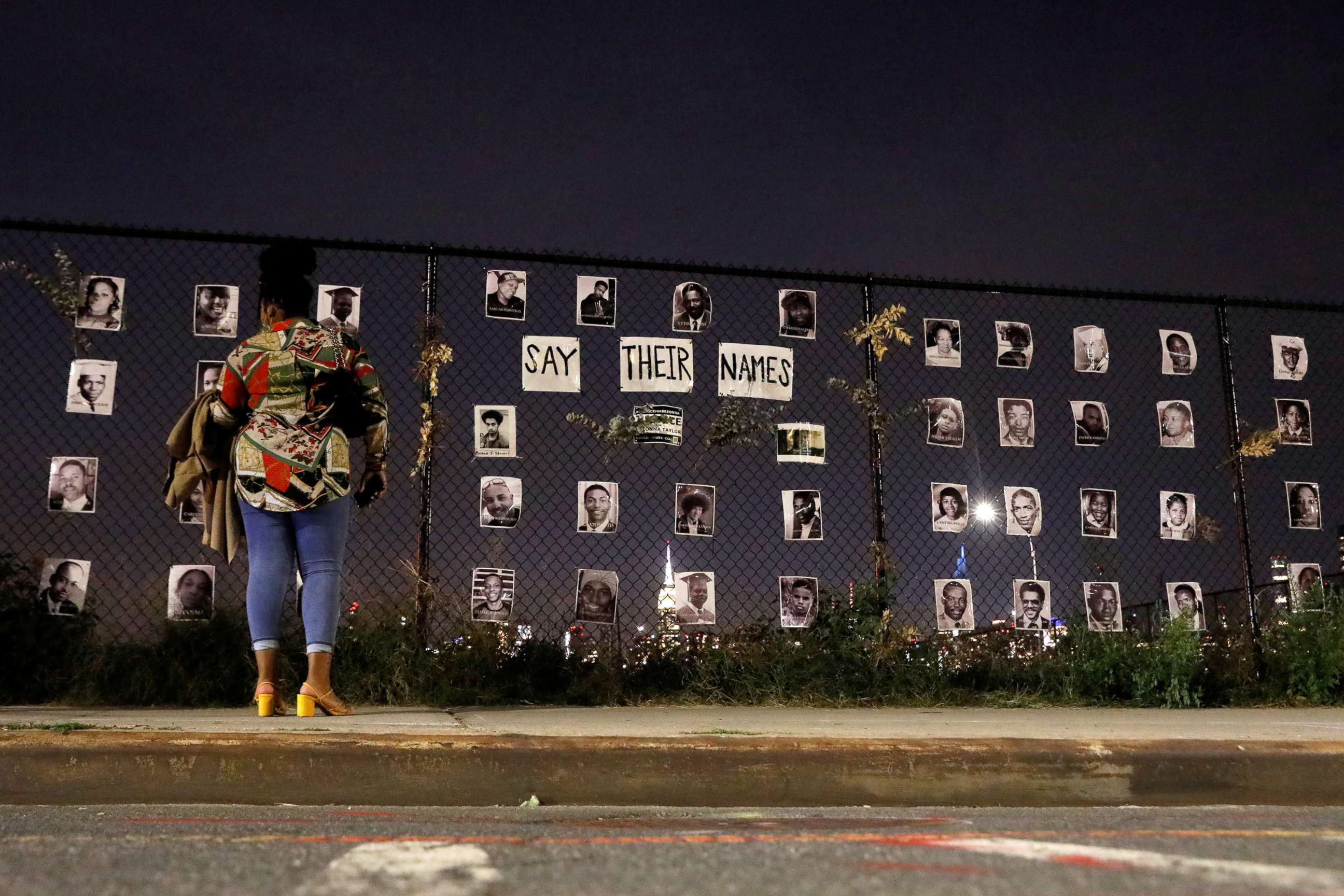 PHOTO: A woman stands in front of a makeshift memorial for victims of racial injustice following the announcement of a single indictment in the Breonna Taylor case, in the Brooklyn borough of New York City, Sept. 24, 2020.