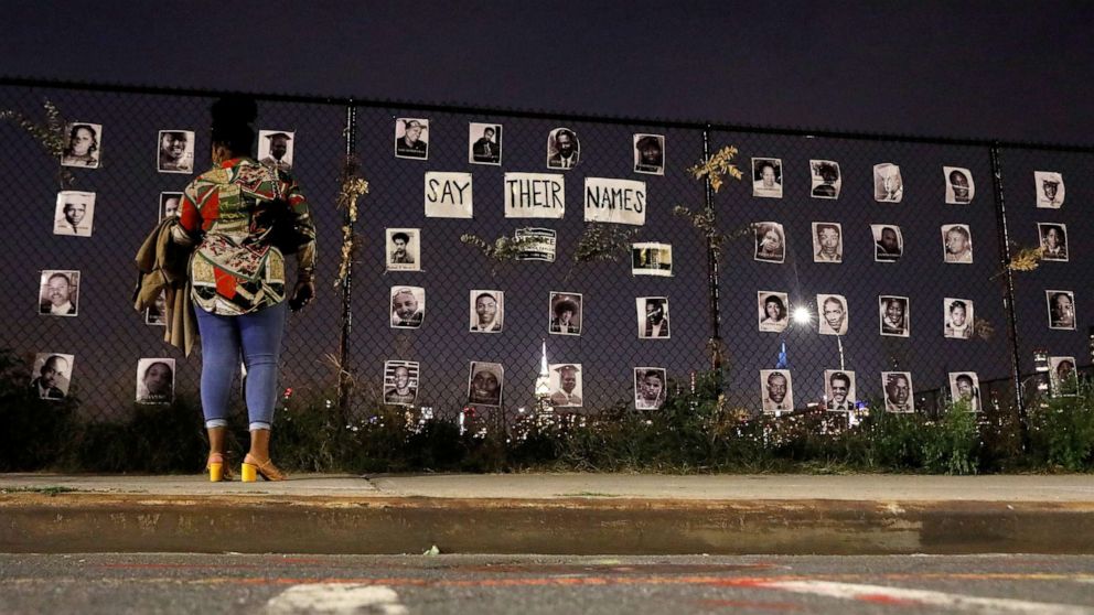 PHOTO: A woman stands in front of a makeshift memorial for victims of racial injustice following the announcement of a single indictment in the Breonna Taylor case, in the Brooklyn borough of New York City, Sept. 24, 2020.