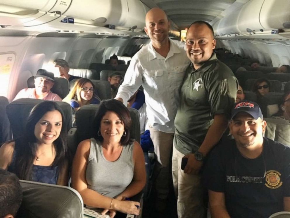 PHOTO: Nancy Alvarez and Marucci Guzman alongside first responders on board one of the first aid flights out of Orlando to Puerto Rico days after Hurricane Maria.