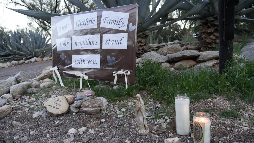 PHOTO: Lit candles next to a sign from neighbors supporting the Guthrie family outside of Nancy Guthrie's house, Feb. 8, 2026 in Tucson, Ariz.