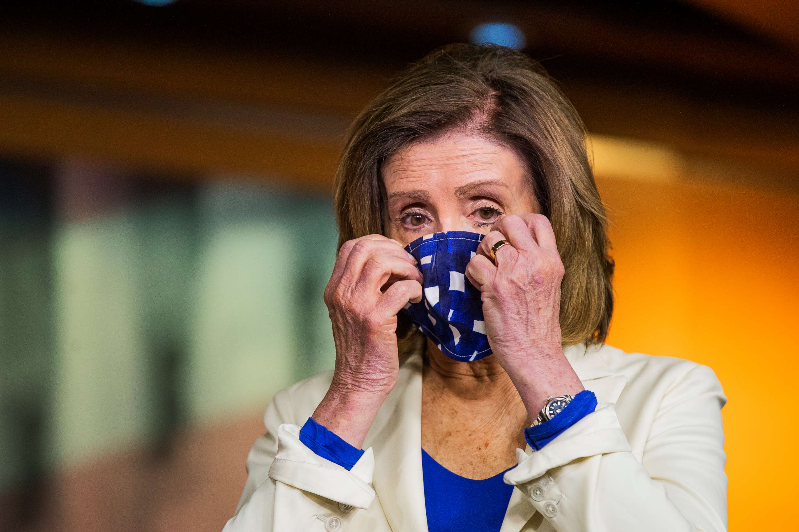 PHOTO: House Speaker Nancy Pelosi of Calif. adjusts her face mask during a news conference on Capitol Hill, April 30, 2020, in Washington.