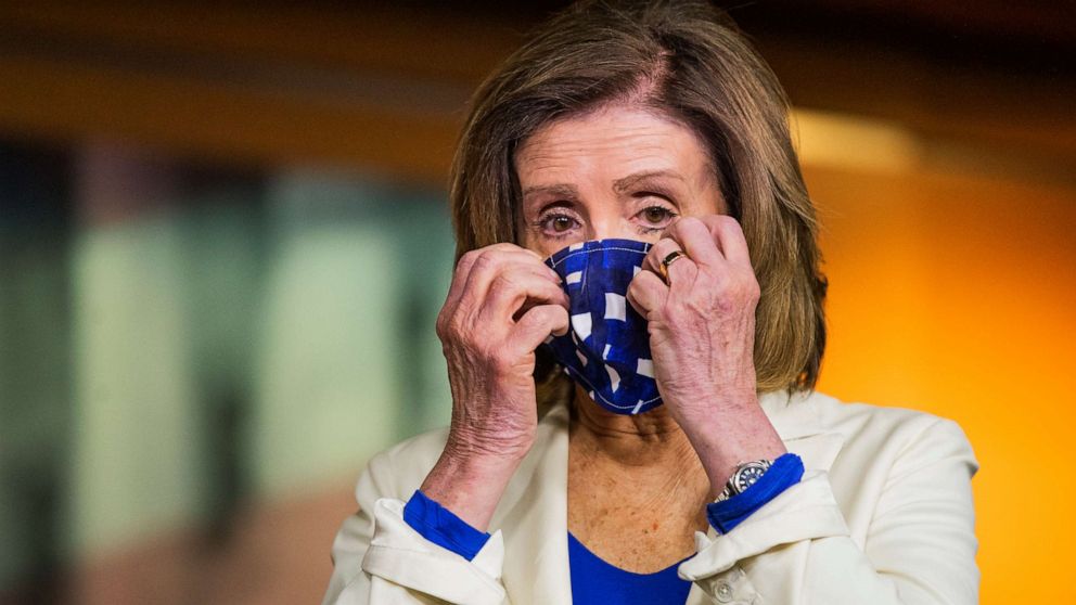 PHOTO: House Speaker Nancy Pelosi of Calif. adjusts her face mask during a news conference on Capitol Hill, April 30, 2020, in Washington.