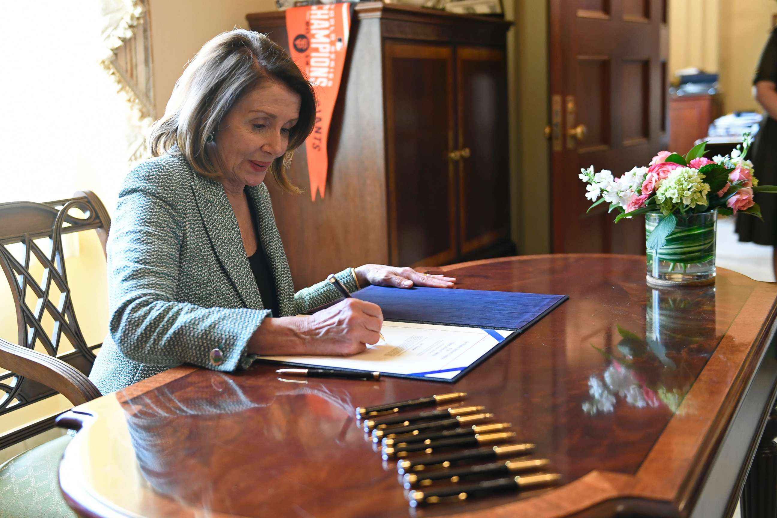 PHOTO: House Speaker Nancy Pelosi of Calif., signs H.J. Res 46, a disapproval resolution that blocks President Trump's national emergency declaration, on Capitol Hill in Washington, March 14, 2019.