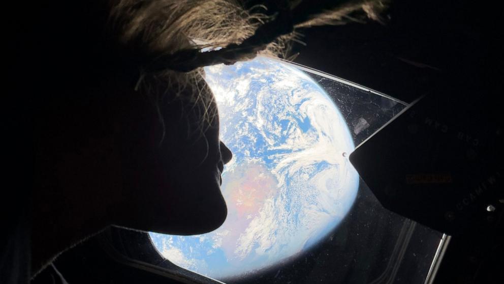 PHOTO: Mission Specialist 1 Christina Koch gazing at Earth from Orion’s windows, a reminder of home as they travel toward the moon.