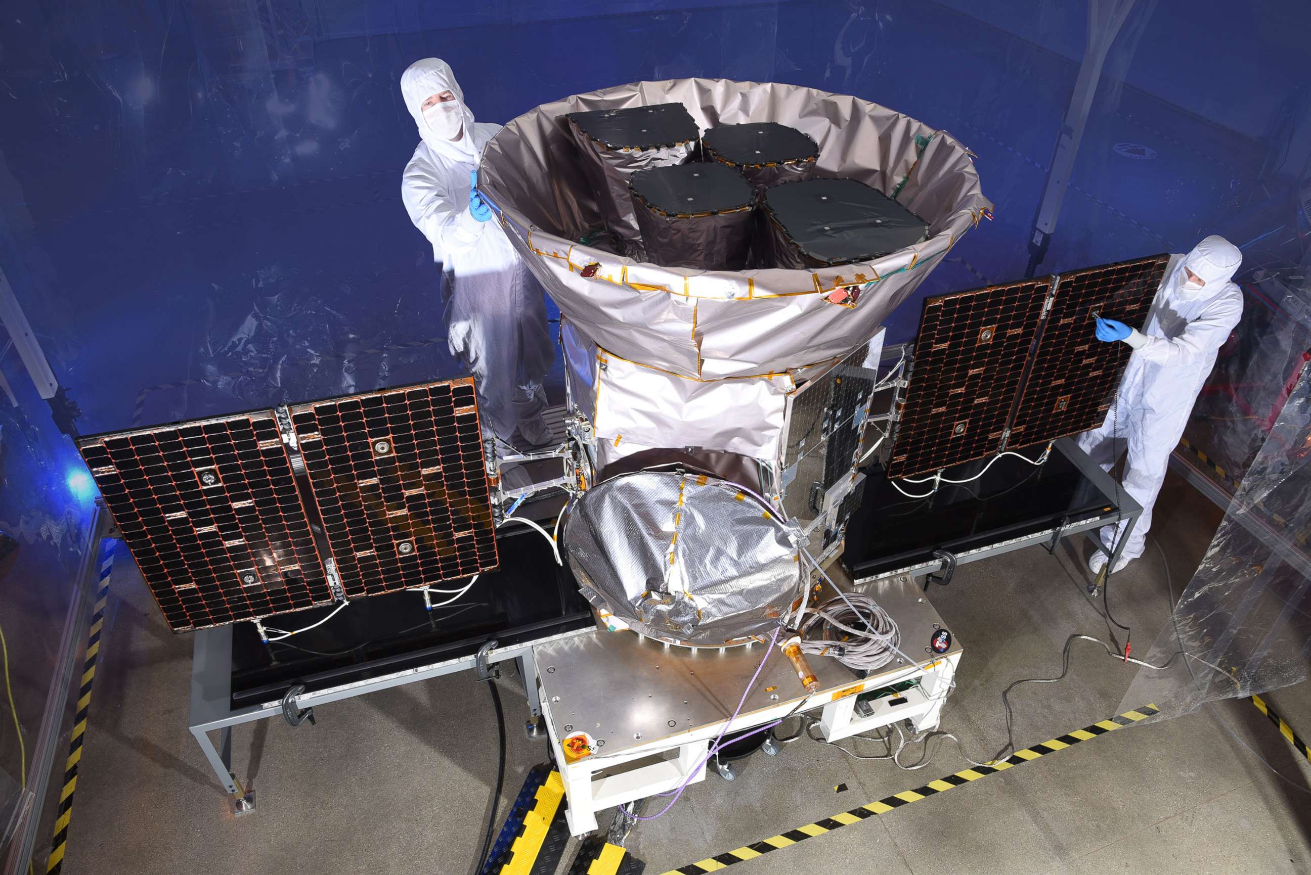 PHOTO: TESS, the Transiting Exoplanet Survey Satellite, is pictured with NASA technicians in an image released on March 28, 2018.