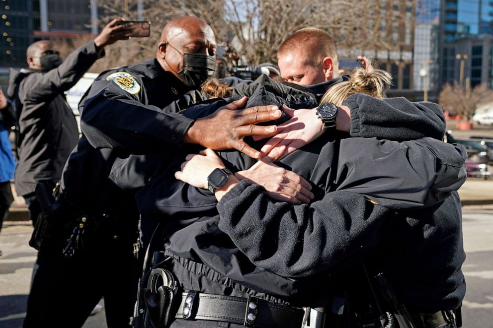 PHOTO: Nashville Police Chief John Drake, left, joins a group of police officers as they embrace after speaking at a news conference, Dec. 27, 2020, in Nashville, Tenn. 